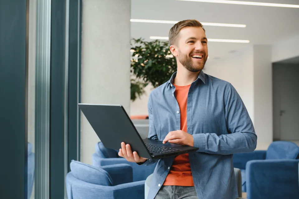 handsome young businessman, using a laptop in the cafe.